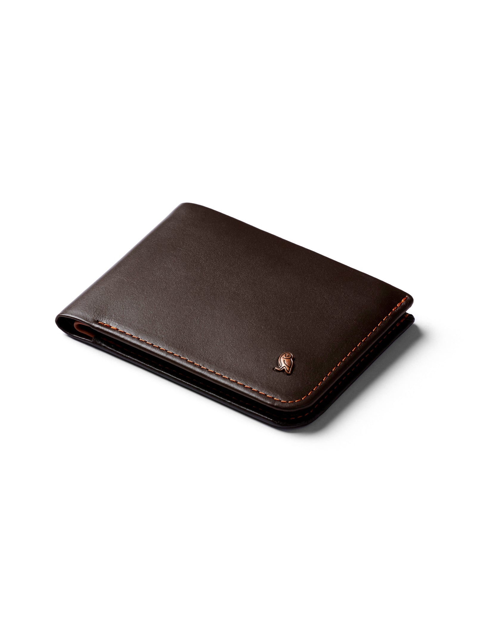 The Bellroy Hide and Seek Low Wallet is a closed, minimalist dark brown eco-tanned leather wallet with RFID protection and a small metallic emblem on one corner, shown on a white background.