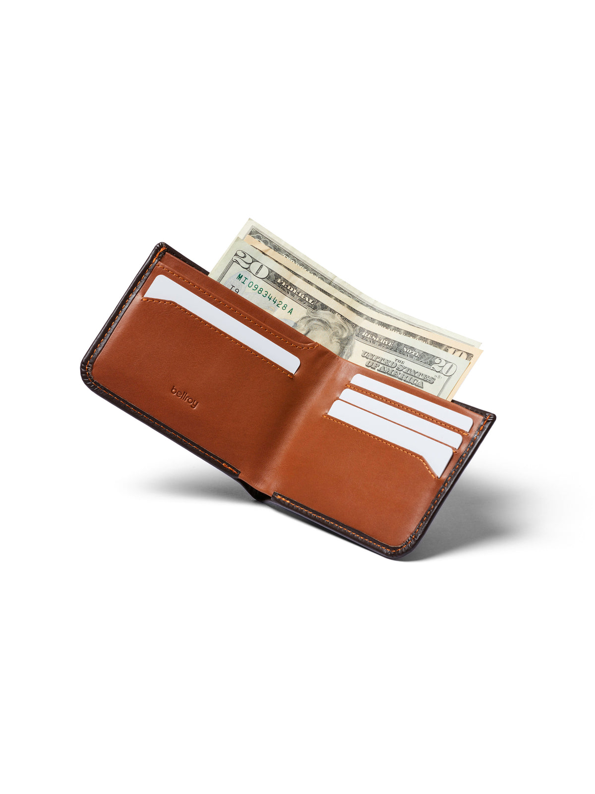 The Bellroy Hide and Seek Low Wallet in brown eco-tanned leather is shown open with cards and U.S. dollar bills inside, set on a white background with a shadow beneath. It features RFID protection for extra security.