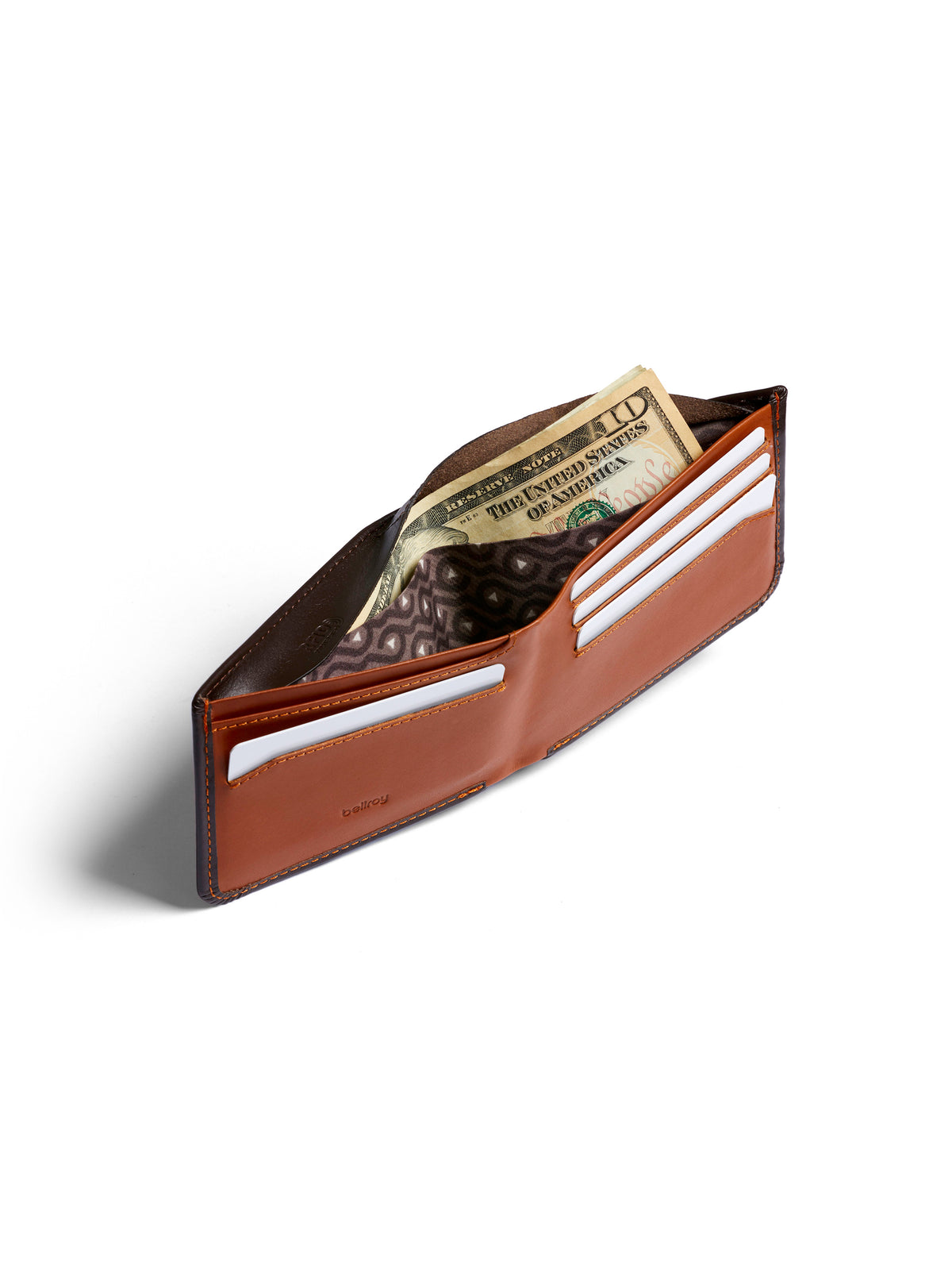 The Bellroy Hide and Seek Low Wallet, crafted from brown eco-tanned leather, is shown open on a white background with US dollar bills, credit card slots, and a hidden coin pouch visible.
