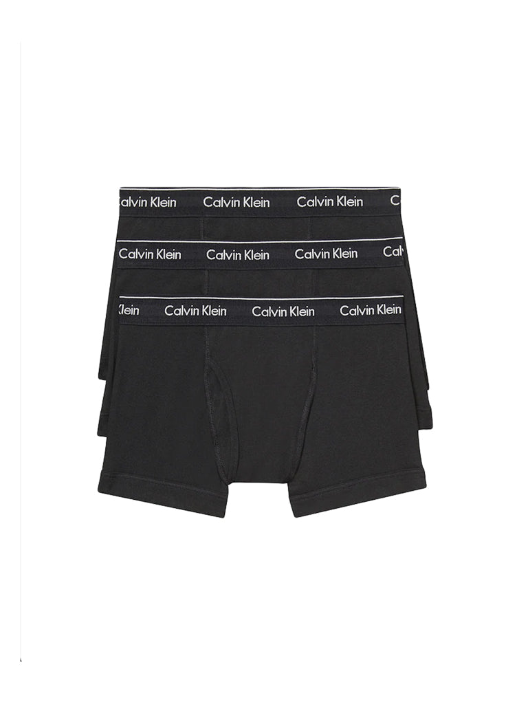 Three pairs of Calvin Klein NB4002 3-Pack Cotton Classic Fit Trunks are stacked, showcasing the white logo on each waistband. These men's trunks provide classic comfort and timeless style.