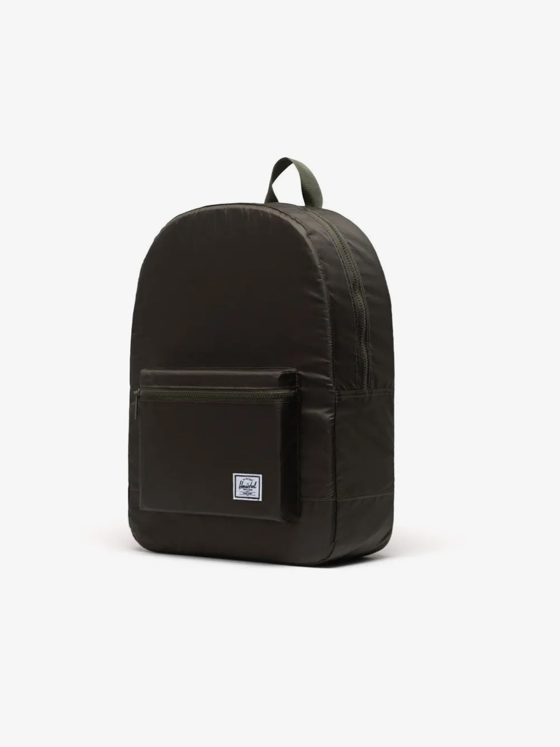 The Herschel Packable Daypack by Herschel is a dark green backpack with a front zip pocket, adjustable shoulder straps, top handle, and a small white rectangular logo patch on the front pocket, shown against a plain white background.