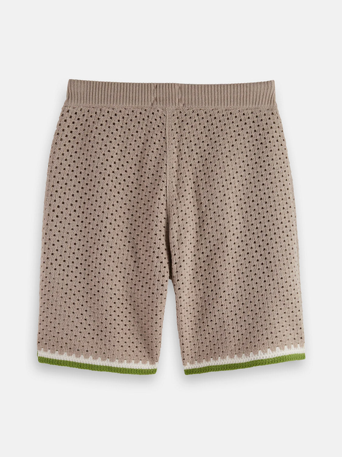 The Crochet Knit Short 180344 SU25 by SCOTCH AND SODA features beige crochet fabric with a perforated eyelet pattern, an elastic waistband, and green and white hem trim, displayed flat on a white background.