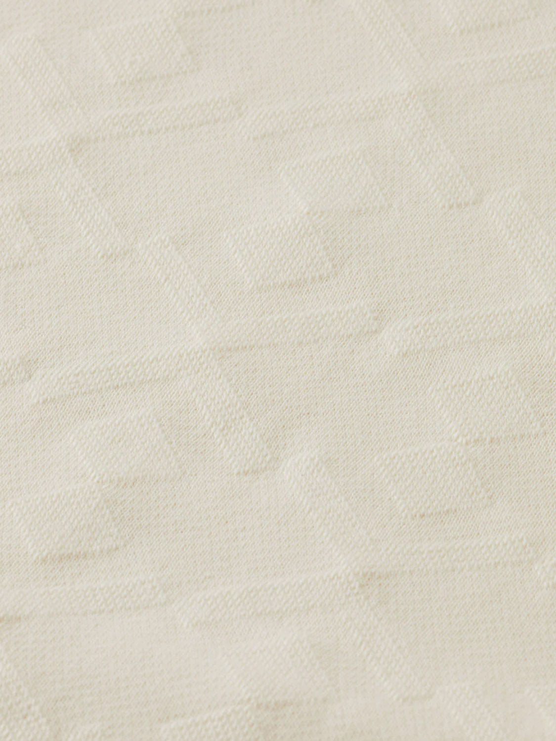 A close-up of Scotch & Soda's 181210 Jacquard Terry Sweatshorts shows the cream-colored fabric with a subtle, raised geometric pattern for a textured, sophisticated look.