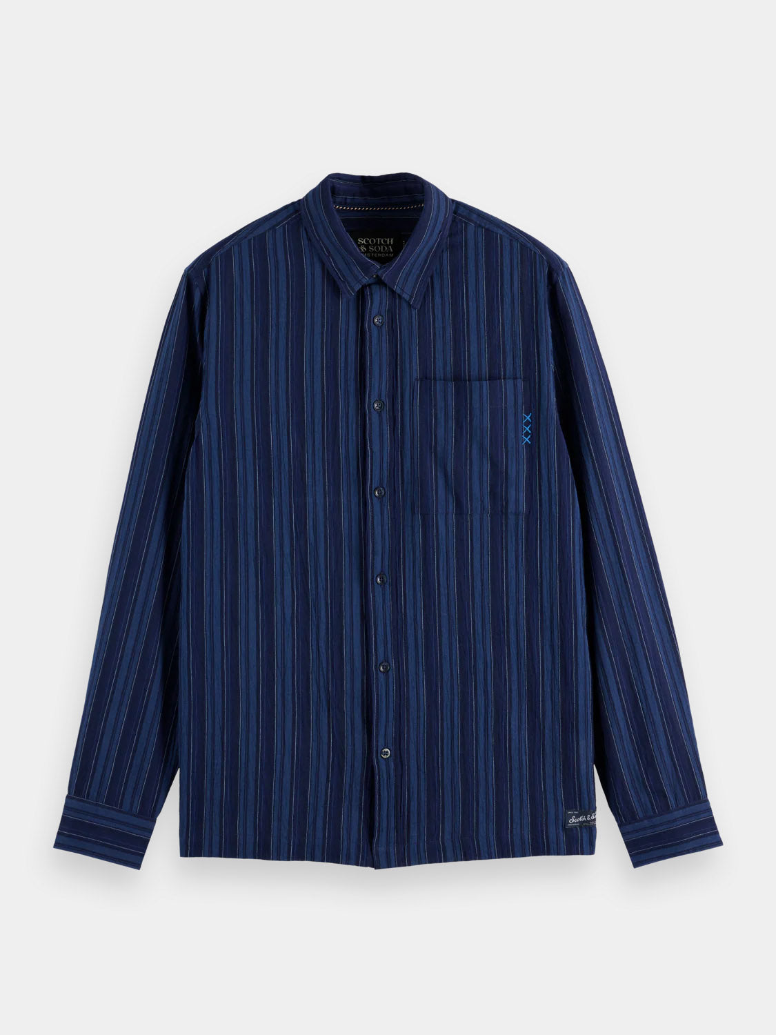 The Scotch & Soda 181248 - Textured Stripe Shirt is a blue and black vertical-striped, long-sleeve cotton shirt with a chest pocket, small embroidered logo, and is shown flat on a white background.