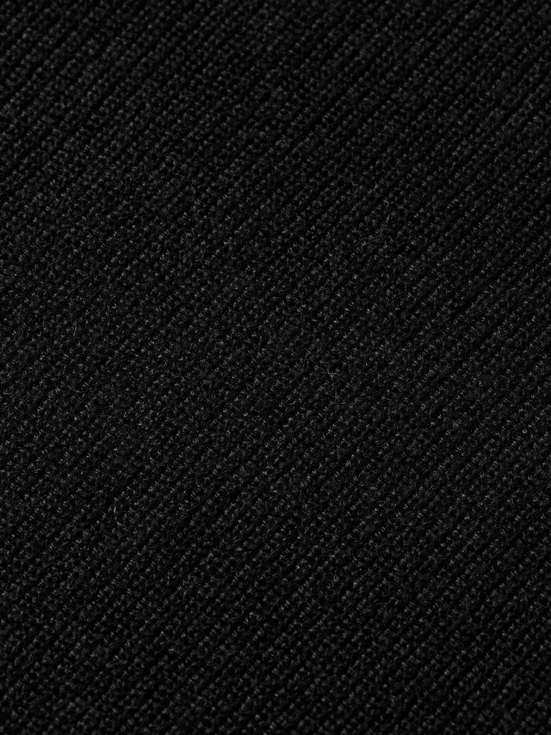 Close-up view of the textured black fabric on the Scotch & Soda 181773 Cotton Linen V-Neck Pullover, showing fine diagonal lines and subtle weave variations for a soft, matte look.