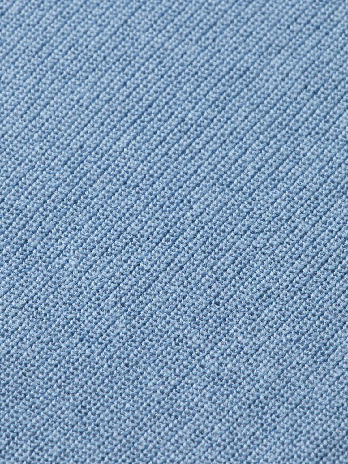 Close-up of a light blue knitted fabric with a diagonal ribbed texture, like the refined finish on Scotch & Soda’s 181773 Cotton Linen V-Neck Pullover.