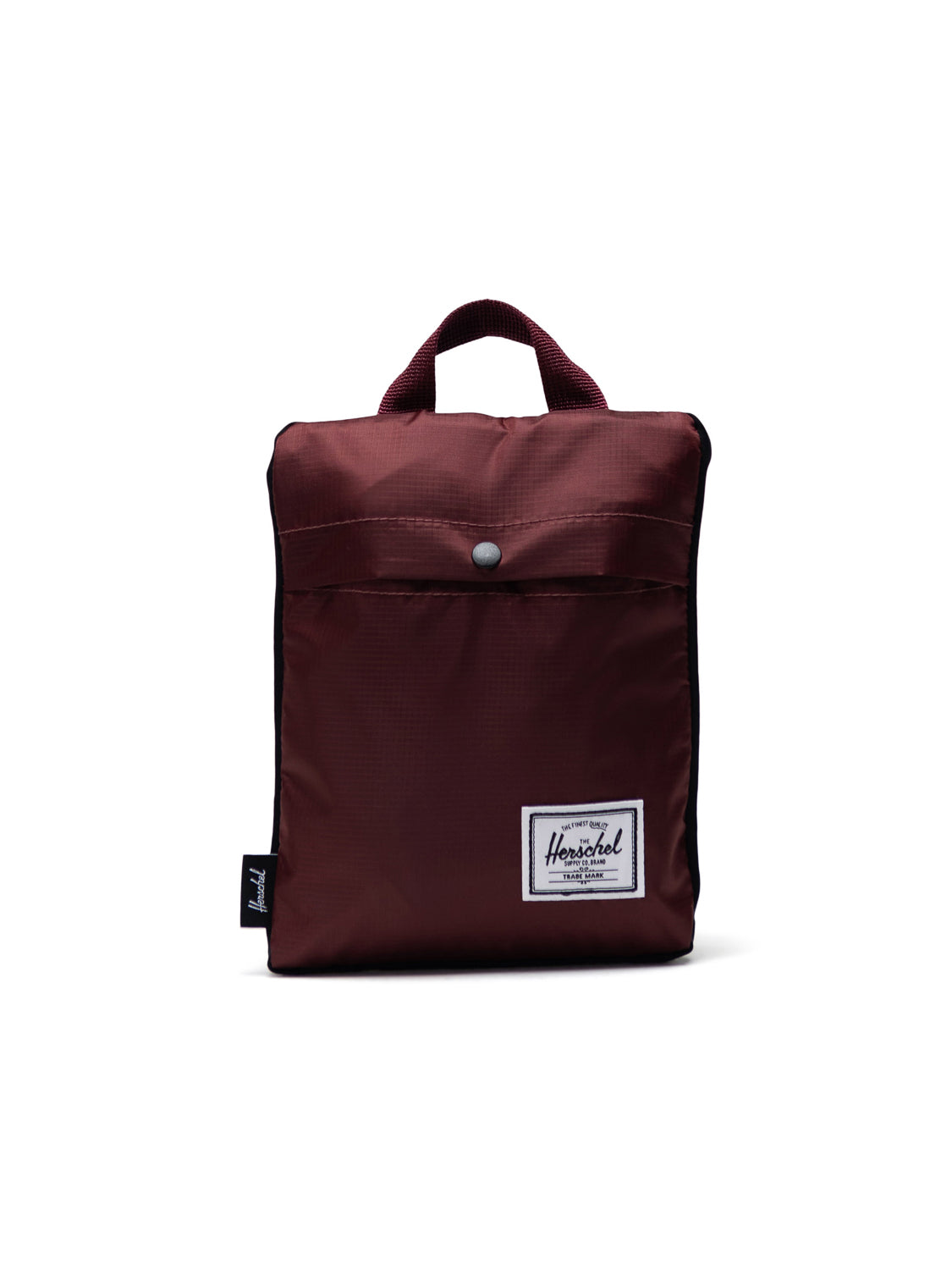 The Herschel Packable Daypack is a compact maroon pouch with a top handle, front snap pocket, and a white rectangular Herschel logo patch on durable ripstop fabric, shown against a plain white background.