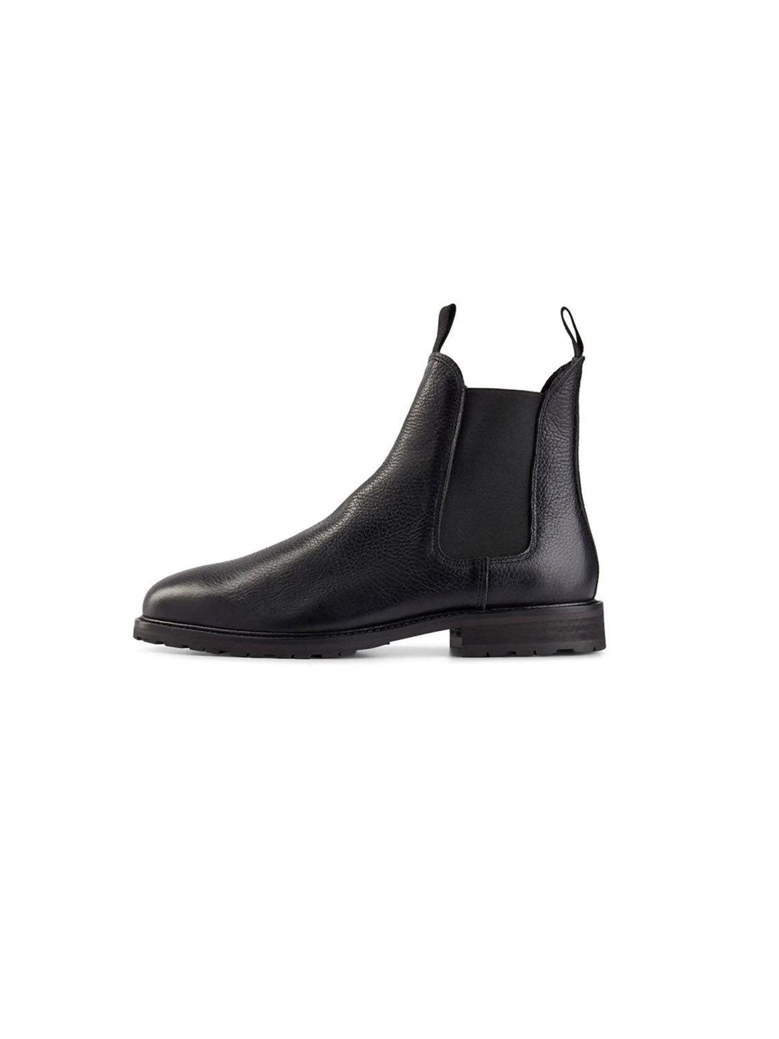 The York Classic Chelsea Boot by Shoe The Bear is a sleek black leather boot with a textured finish, crafted from LWG-certified leather. It features elastic side panels, a back pull tab, and a flexible rubber outsole, all set against a white background with its low heel design.