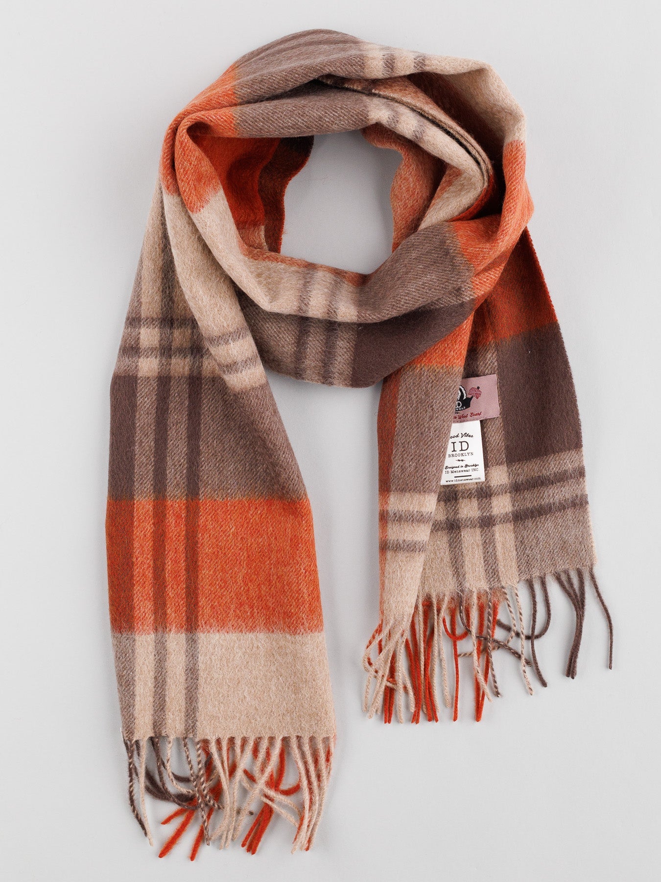 The Wool Timeless Checked Scarf by ID Menswear features a U-shaped design with orange, beige, and brown stripes on a neutral gray wool background. This winter accessory has self-fringed edges and a stylish tag.