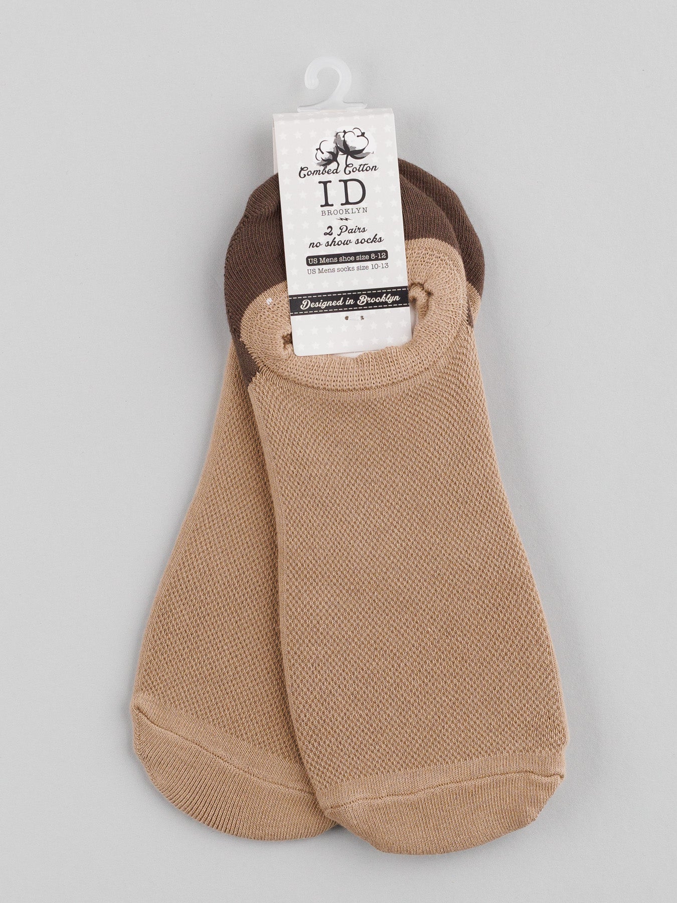 M5 Combed Cotton Socks by ID Menswear are no-show socks made from breathable combed cotton in beige and brown, elegantly packaged with a cardboard label featuring text and a logo on a plain gray background.