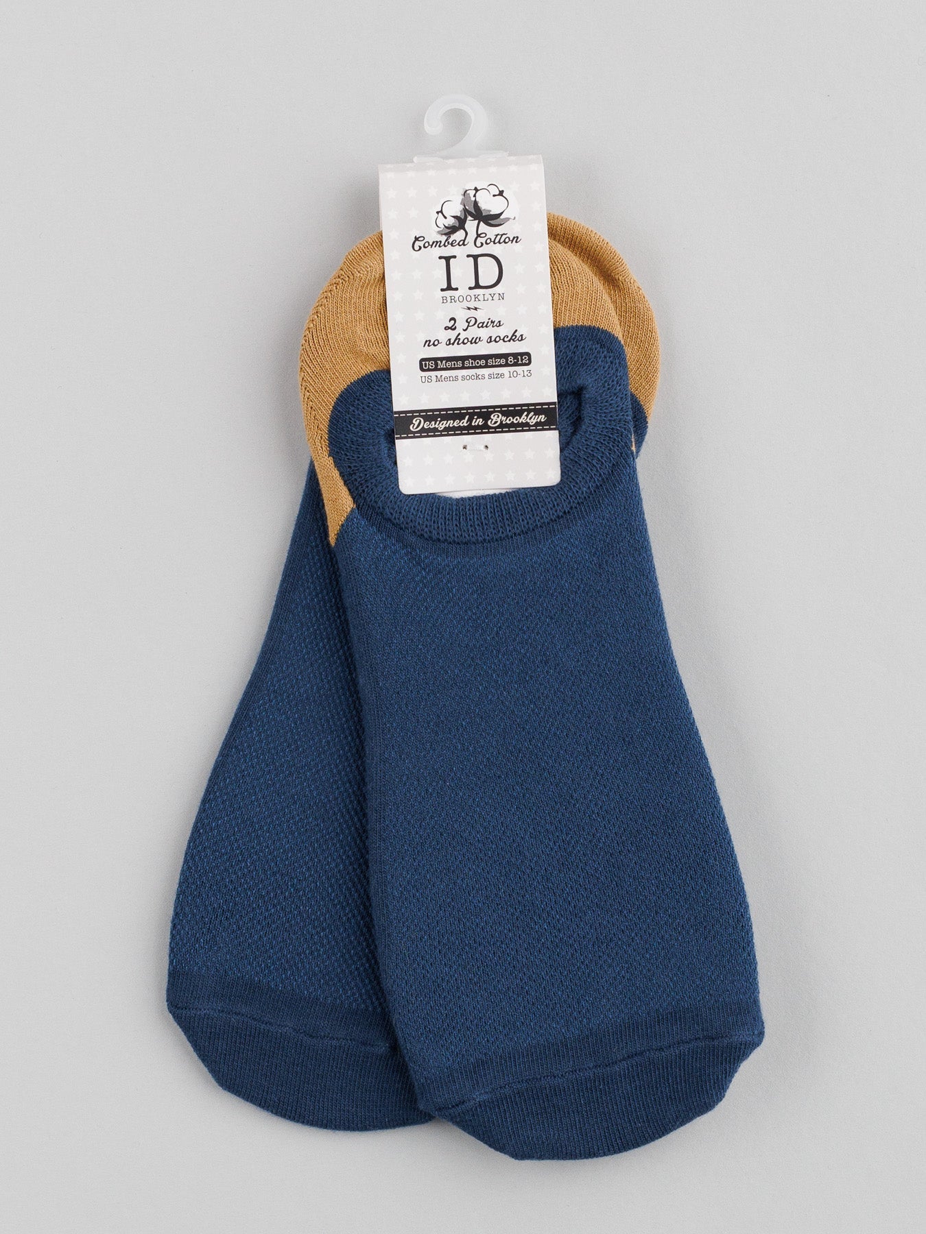 A pair of folded blue and tan no-show M5 Combed Cotton Socks by ID Menswear, featuring a cat logo and Combi Lecture & Anti-Slip text, is elegantly displayed on a plain gray background.