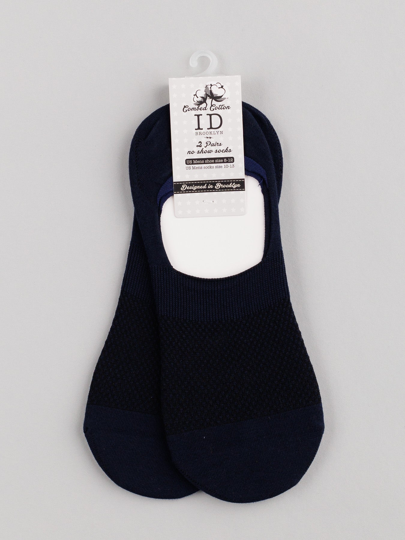 ID Menswears M1 No Show Socks in black, made from soft combed cotton with a mesh-like pattern perfect for low-cut shoes, are showcased on light gray background with a cardboard label displaying brand and product details.