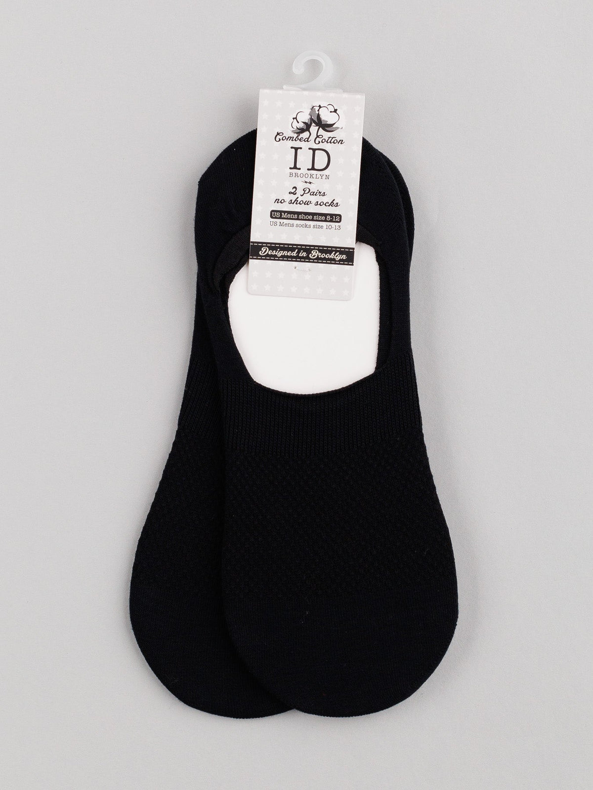 Two pairs of ID Menswear’s black M1 No Show Socks, made from combed cotton, are gracefully displayed on a plain background. They feature a label and a small hanger at the top, making them ideal for low-cut shoes.