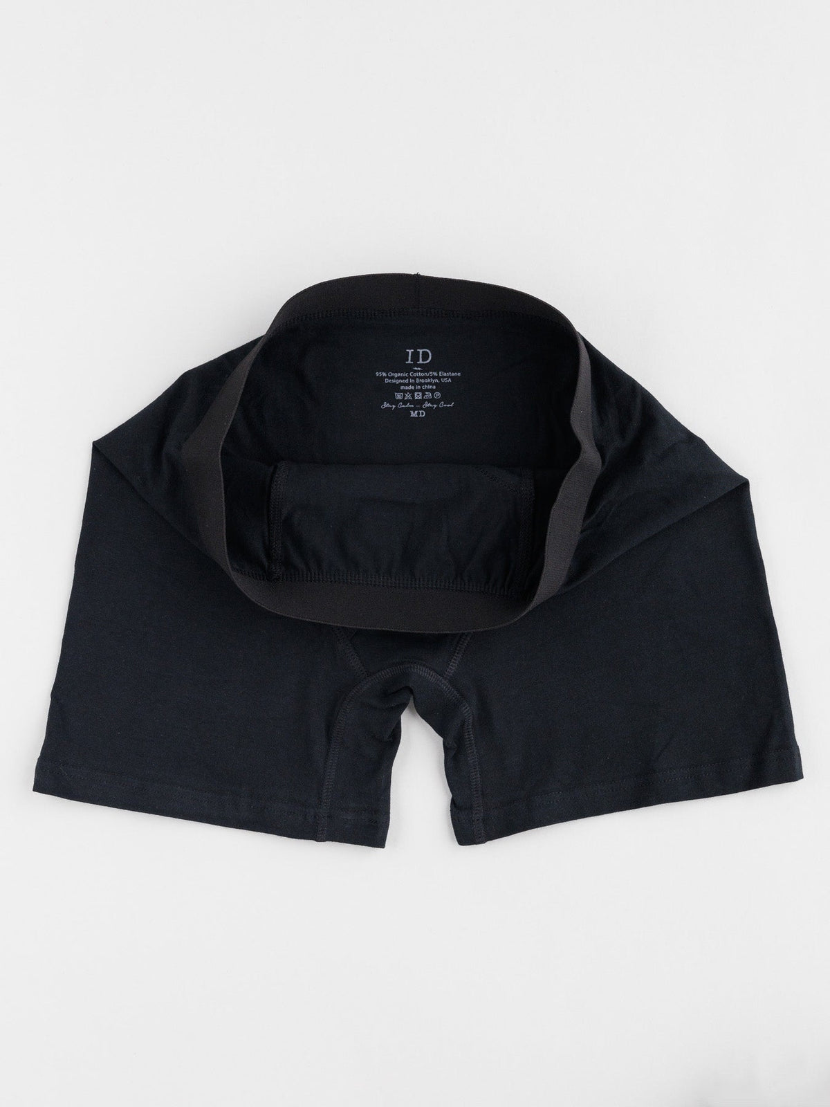 A black pair from the ID Organic Cotton Boxer Briefs 3 Pack by ID Menswear is laid flat on a white background, showcasing its waistband and interior. Made from smooth, stretchy fabric, these essentials offer all-day comfort.