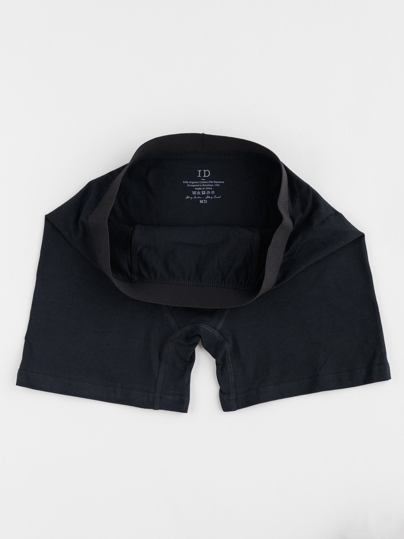 A black pair from the ID Organic Cotton Boxer Briefs 3 Pack by ID Menswear is laid flat on a white background, showcasing its waistband and interior. Made from smooth, stretchy fabric, these essentials offer all-day comfort.