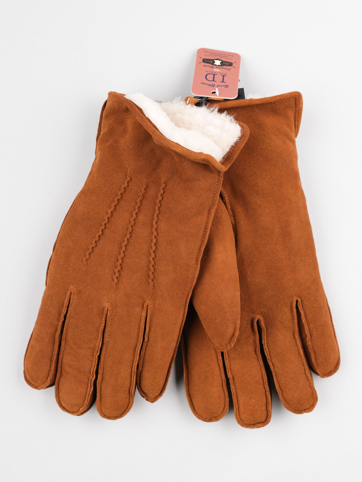 The Sub Zero Shearling Lined Leather Gloves by ID Menswear, featuring brown suede with genuine white fleece lining, are showcased against a white background. A pink tag is attached to the gloves.