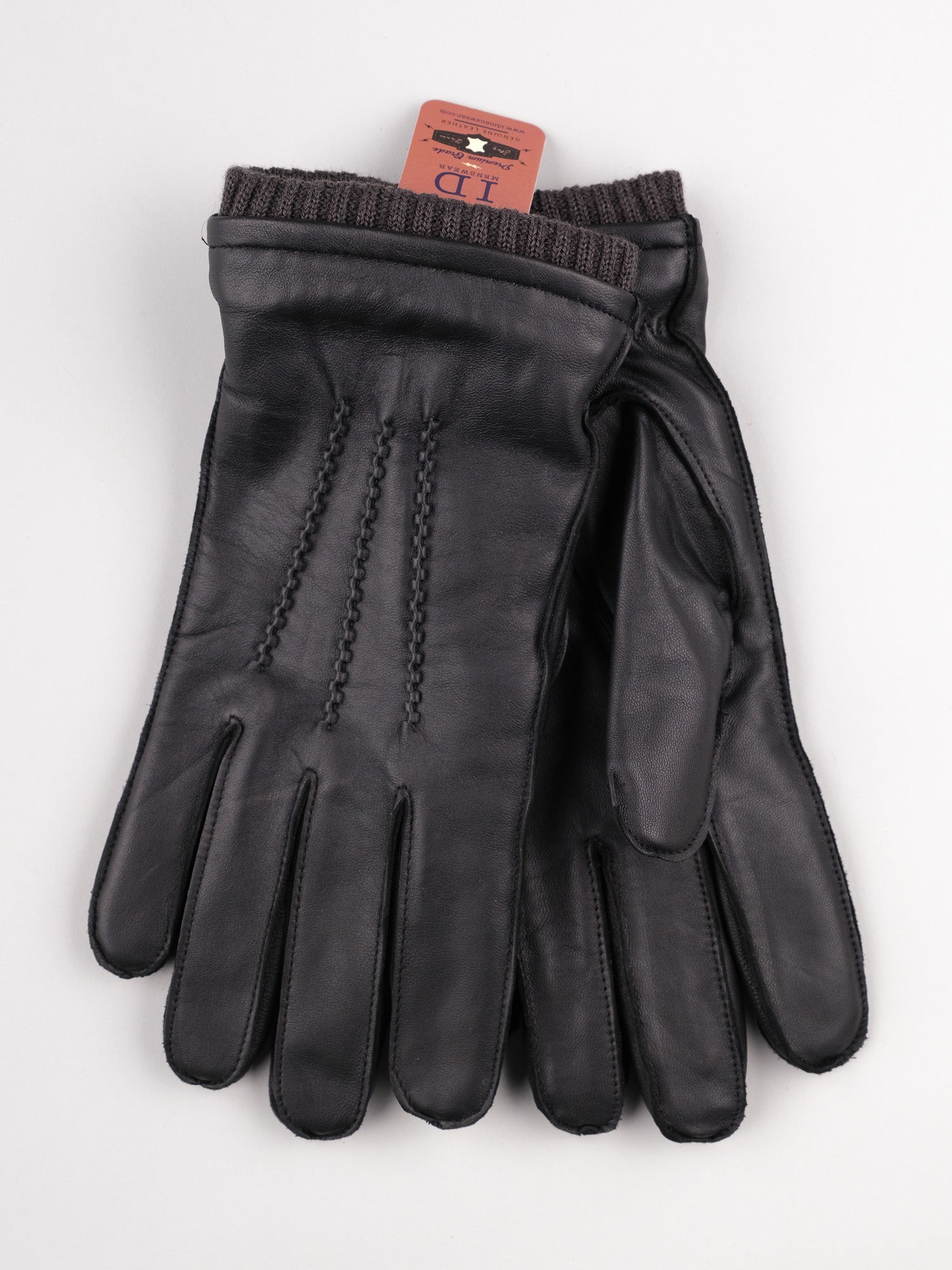 ID Menswears Thinsulate Lined Leather Gloves, made from black sheepskin leather with detailed stitching, are shown against a plain background. They include knitted cuffs and a small red tag with text, offering warmth and comfort in every wear.