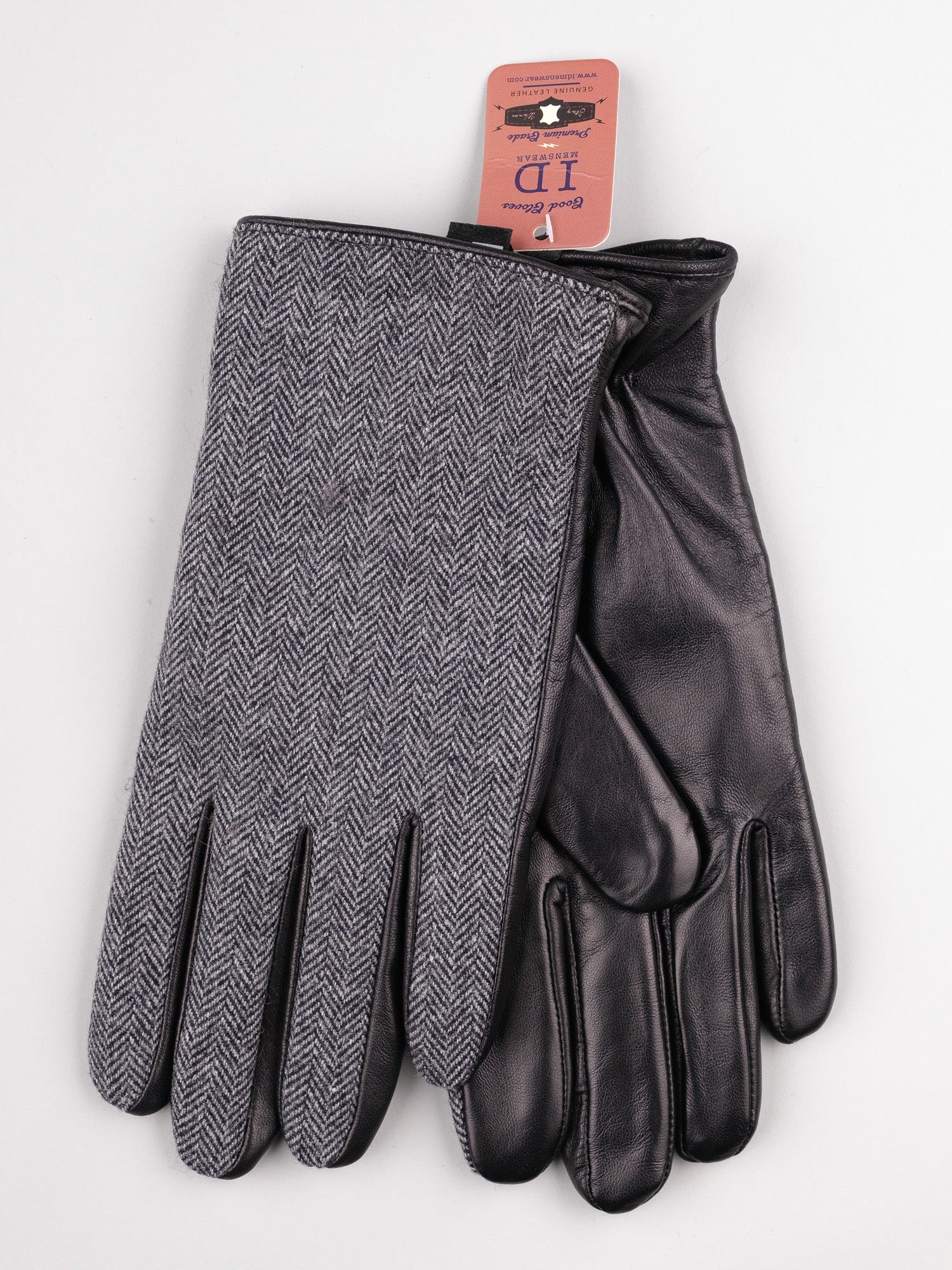 The Nordic Tweed Leather Gloves by ID Menswear include one glove with a gray herringbone pattern and the other in Nordic leather, both offering touchscreen access and displayed with an ID tag on a light background.