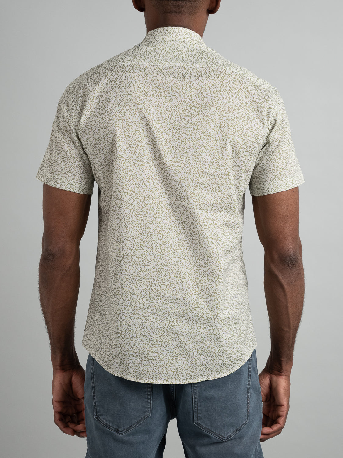 A person is seen from the back wearing the Anise Short Sleeve Cotton Printed Shirt by ID Menswear, paired with dark jeans against a plain background.