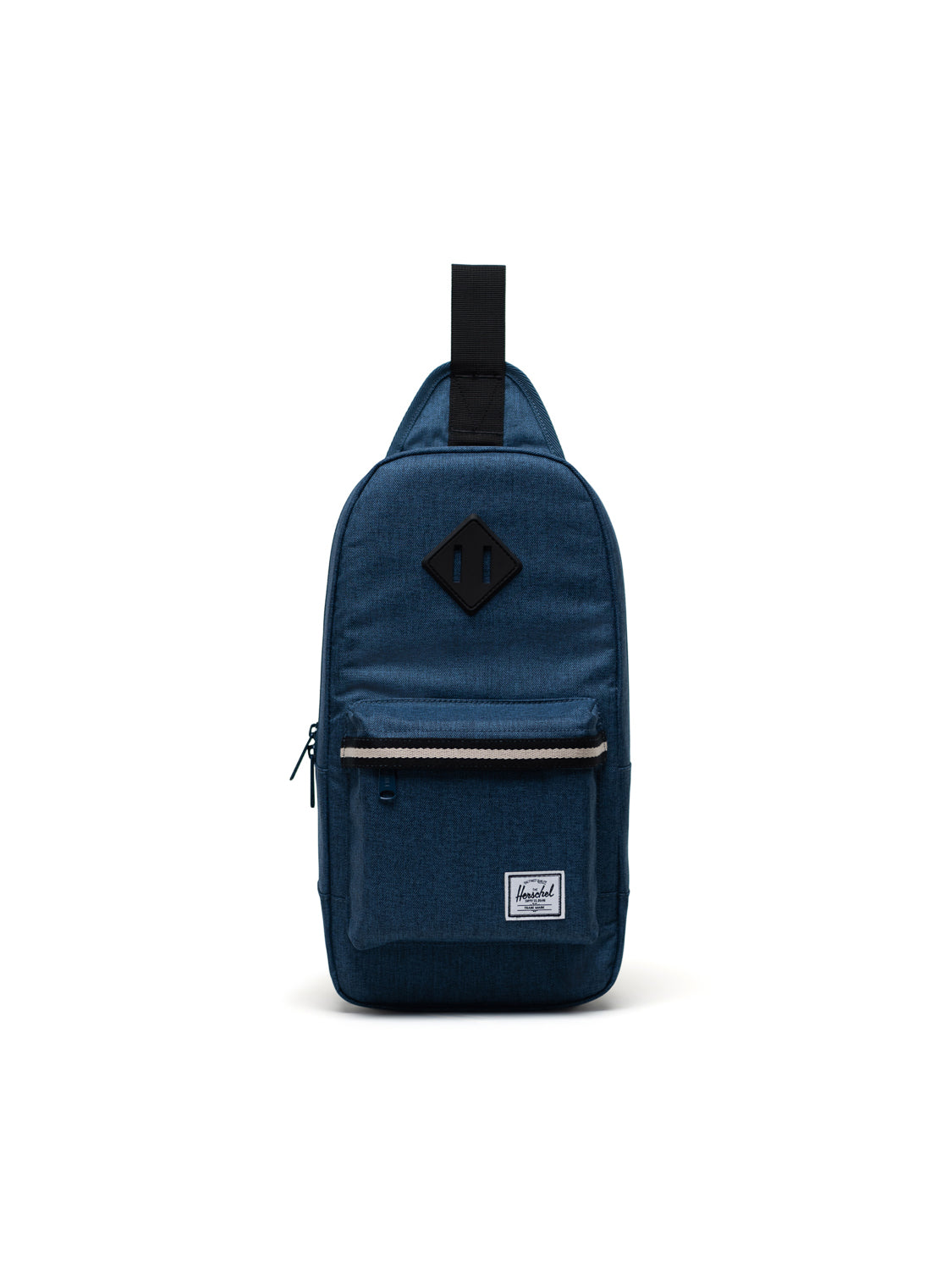 The Herschel Heritage Shoulder Bag features a dark blue design, front zipper pocket, diamond-shaped patch, black top handle, and a small white label near the bottom, displayed against a plain white background.