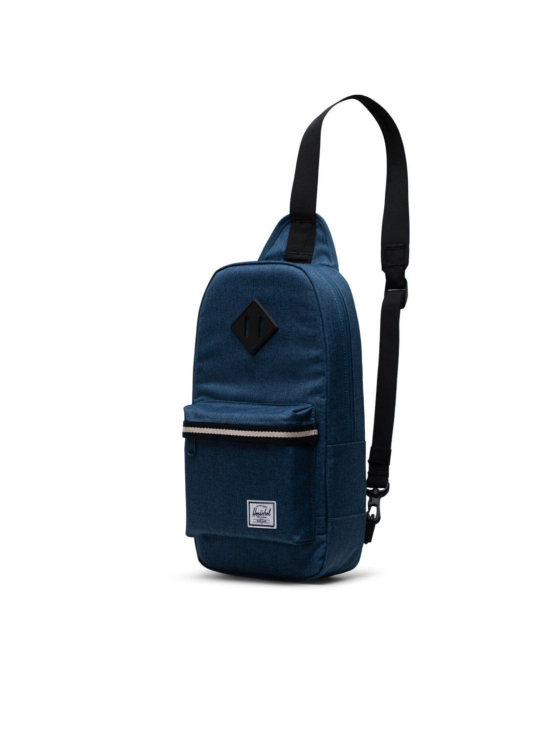 The Herschel Heritage Shoulder Bag is a blue crossbody backpack with a black adjustable strap, front zippered pocket, and a small Herschel logo patch on the lower front, shown upright against a white background.