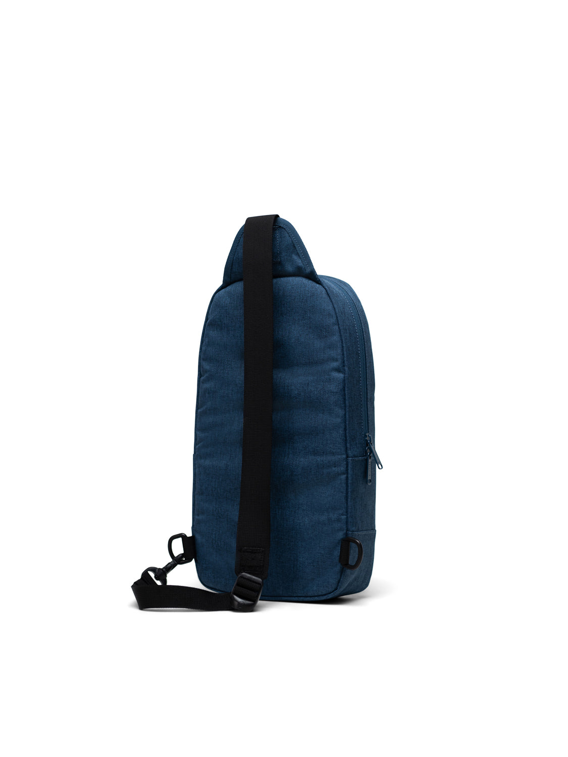 The Herschel Heritage Shoulder Bag is a small, dark blue crossbody backpack with a simple zipper design and a single black adjustable strap, shown upright on a plain white background.