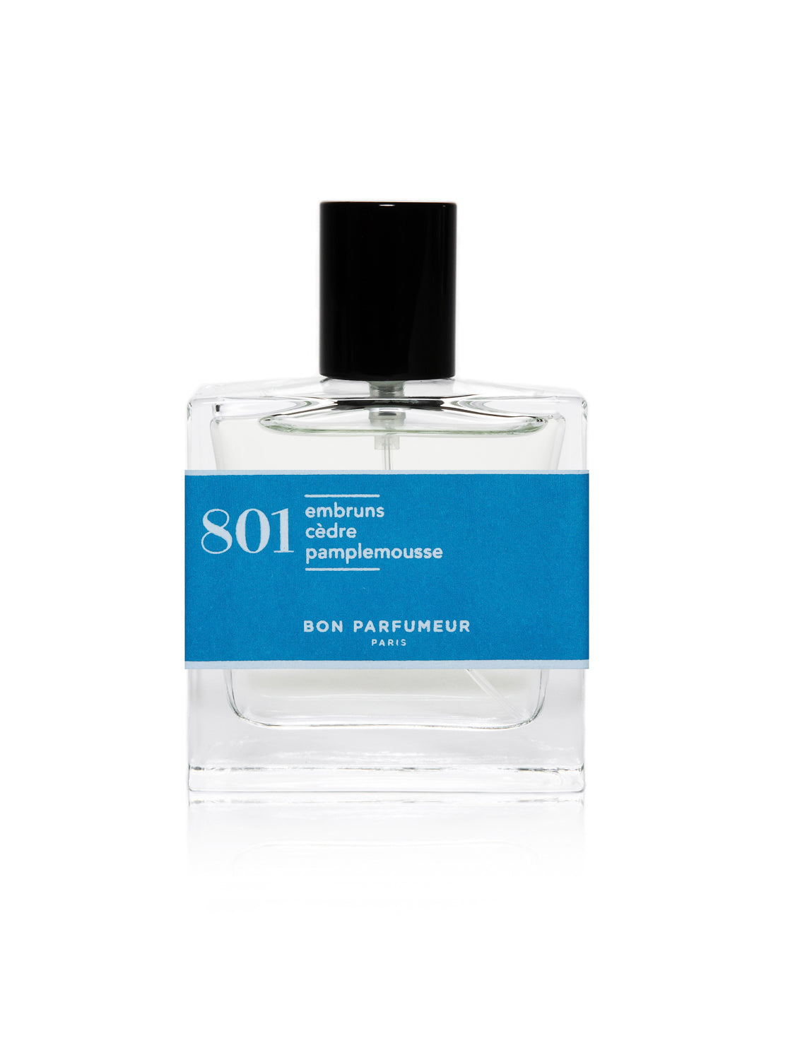 The Bon Parfumeur 801 perfume bottle is clear glass with a light liquid inside and a black cap. It features a blue label reading 801 embruns cèdre pamplemousse and Bon Parfumeur Paris, capturing the refreshing essence of Italian citrus fruits for summer.