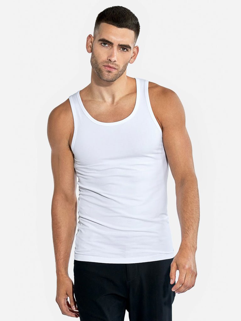 A man with short hair wears a Bread & Boxer 2 Pack Tank Top Cotton Stretch and dark pants, posing against a plain white background. He faces forward with a neutral expression.