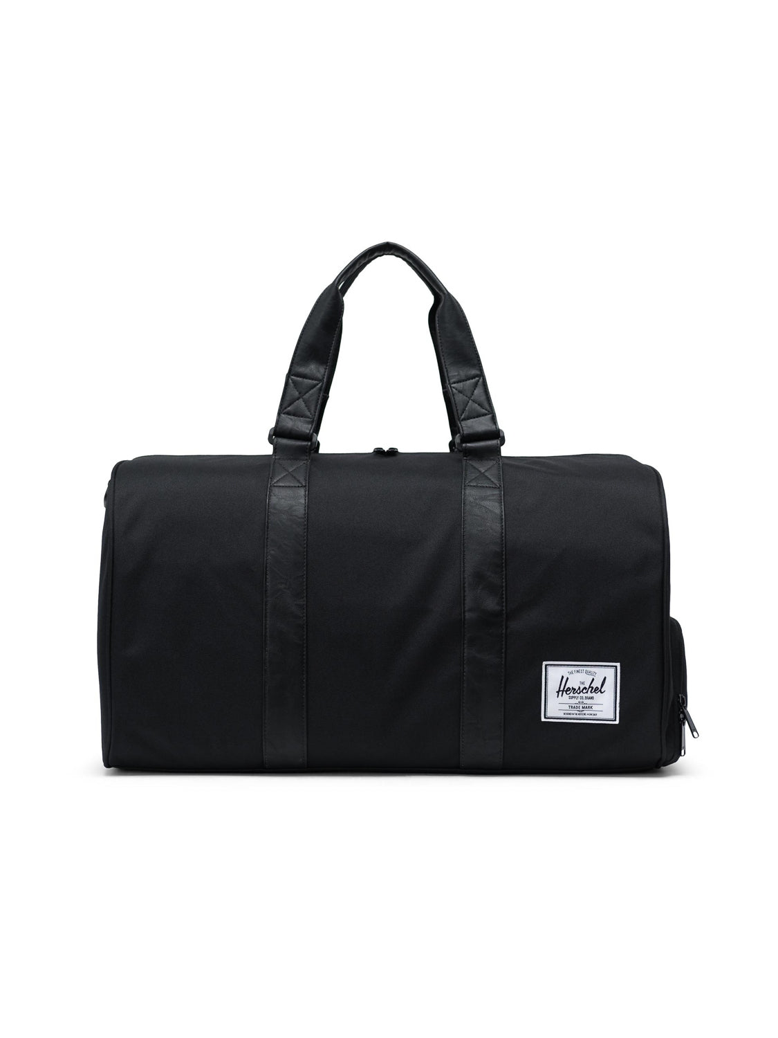 The Herschel Novel Weekender Duffle Bag in black features two handles, a side zipper pocket, shoe compartment, and a white rectangular Herschel label on the front. The bag is shown against a plain white background.