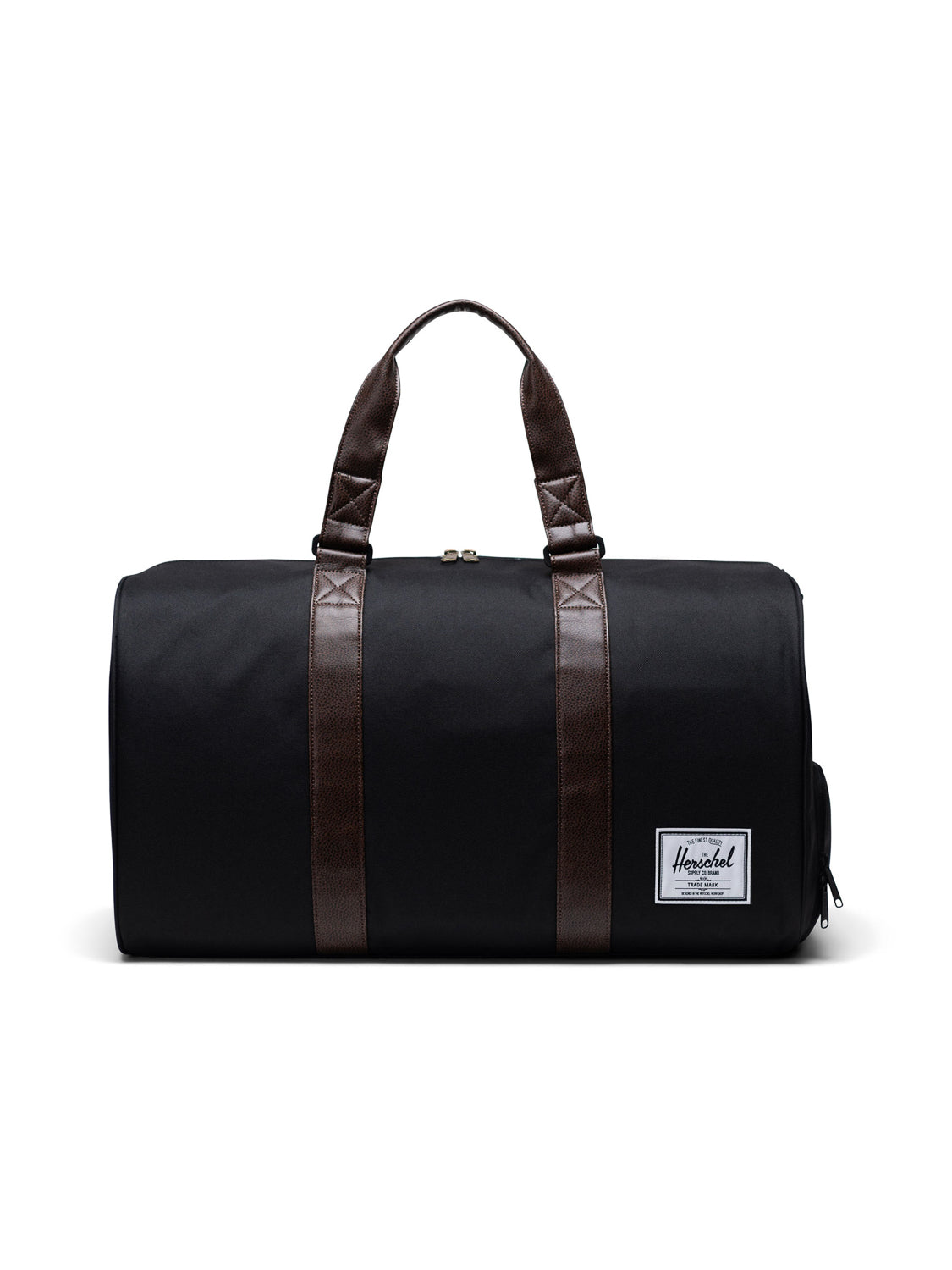 The Herschel Novel Weekender Duffle Bag features black fabric, brown handles, a white rectangular logo patch on the front, and a dedicated shoe compartment, all displayed against a white background.