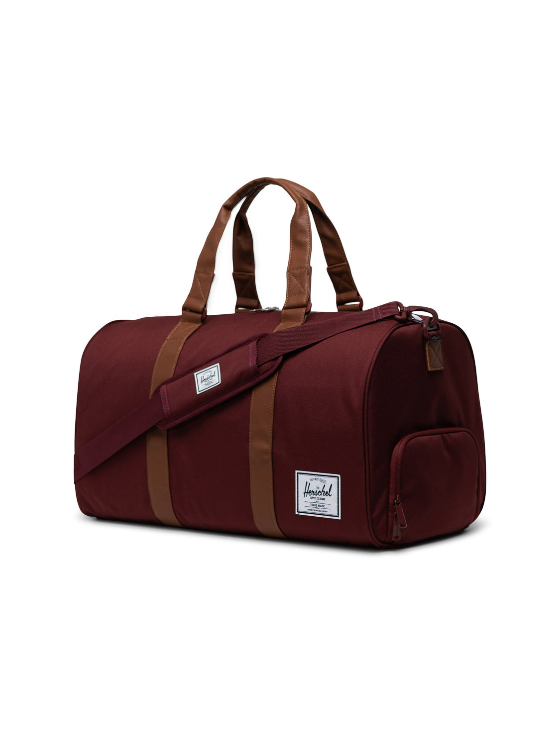 A maroon Herschel Novel Weekender Duffle Bag with tan handles, accents, a shoe compartment, detachable shoulder strap, and a white Herschel logo patch on the front pocket, displayed against a plain white background.