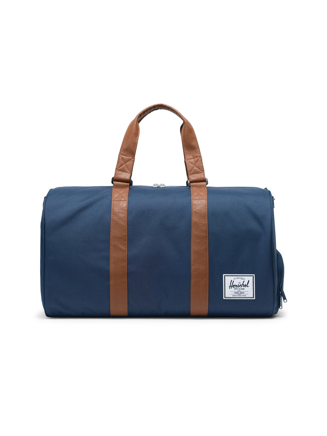 The Herschel Novel Weekender Duffle Bag in navy blue features brown leather handles, a white front logo label, and a handy shoe compartment—ideal as a stylish overnight or travel bag.