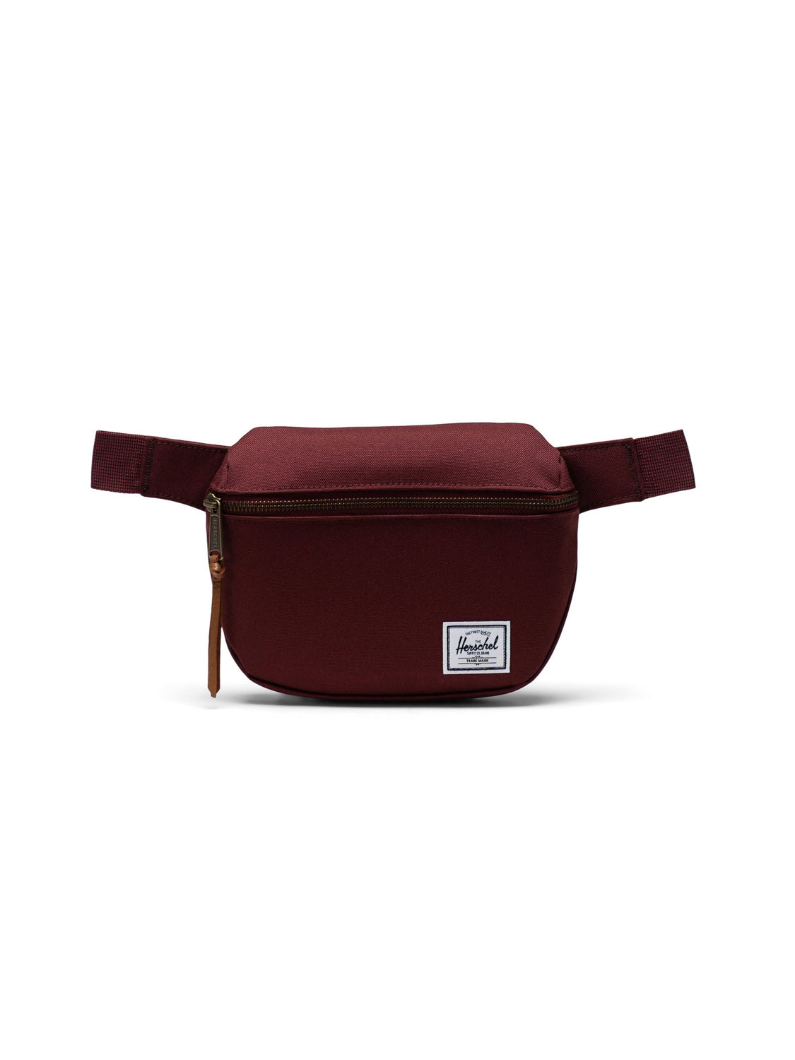 The Herschel Fifteen Hip Pack is maroon with a metal zipper, adjustable strap, and a small white rectangular Herschel label on the front.