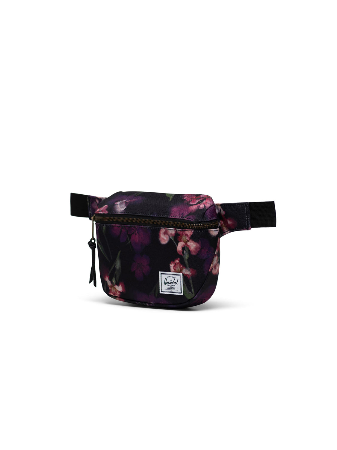 The Herschel Fifteen Hip Pack features a black base with a pink and purple floral pattern, metal zipper, adjustable strap, and a front white Herschel logo patch.