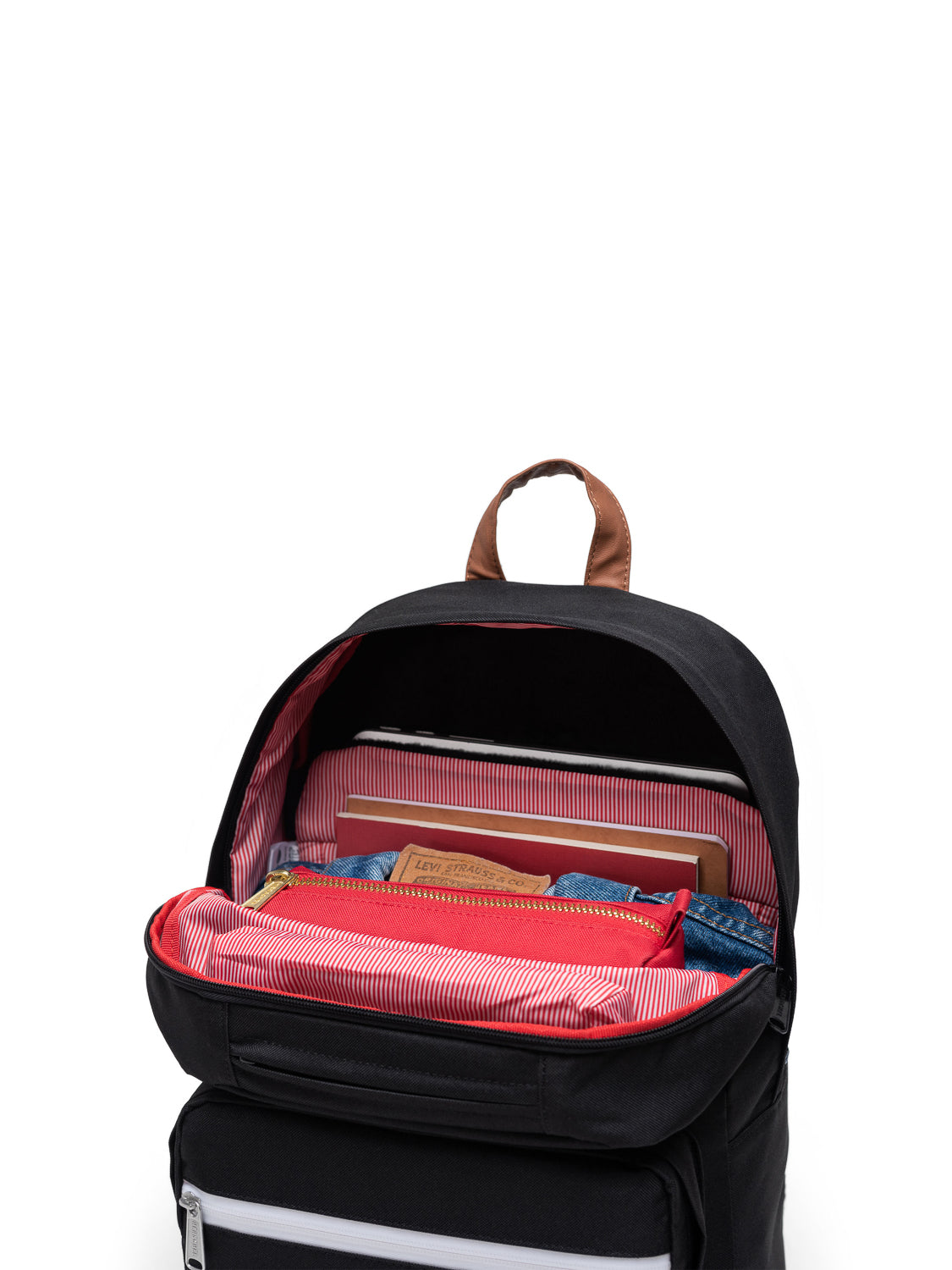The Herschel Pop Quiz Backpack, shown open with its red and white striped lining, holds books, a notebook, and commute essentials in its dedicated laptop sleeve.