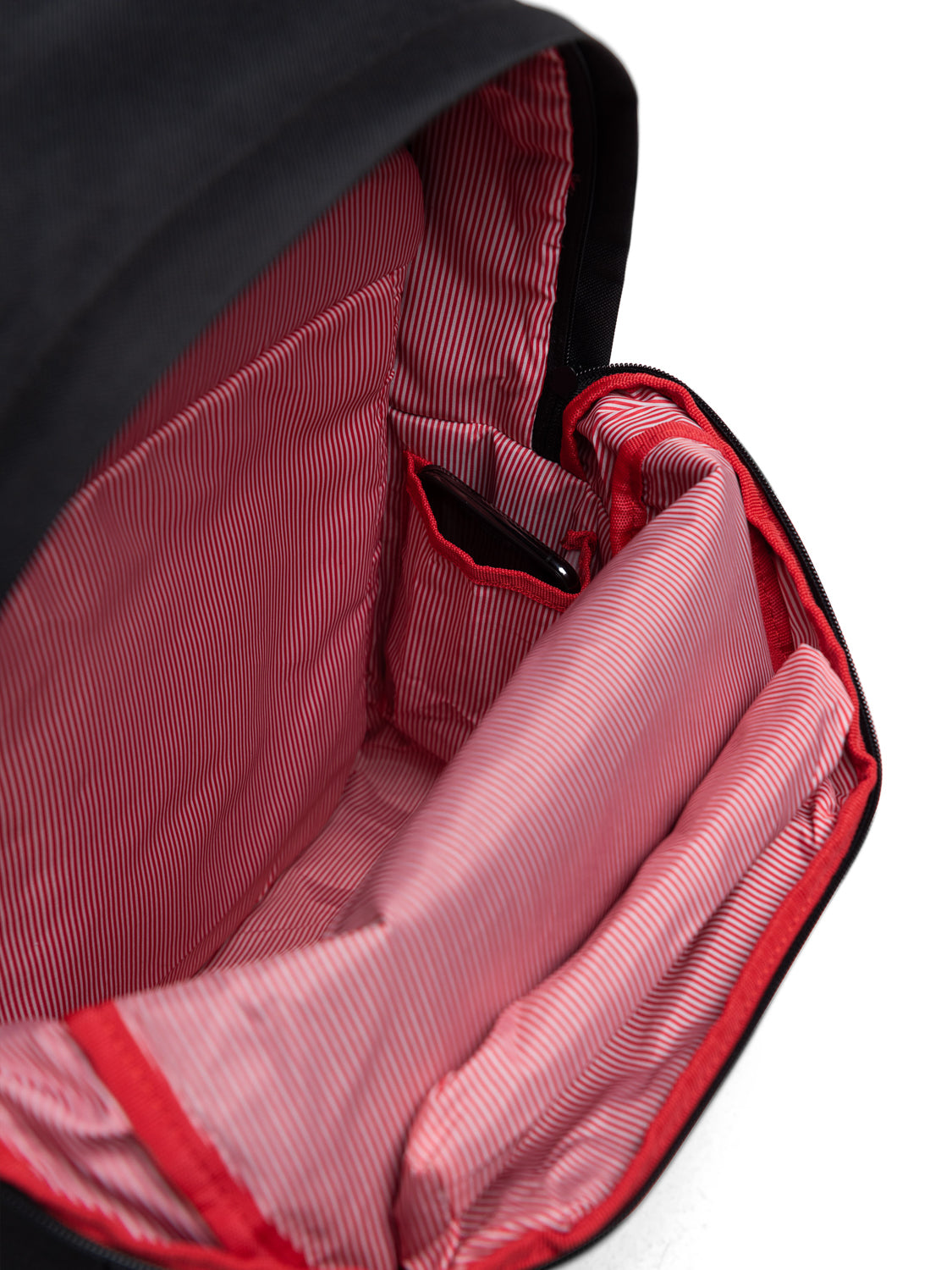 A close-up inside the Herschel Pop Quiz Backpack reveals a red and white striped lining, padded laptop sleeve, compartments, and organizer pockets—ideal for daily commutes.