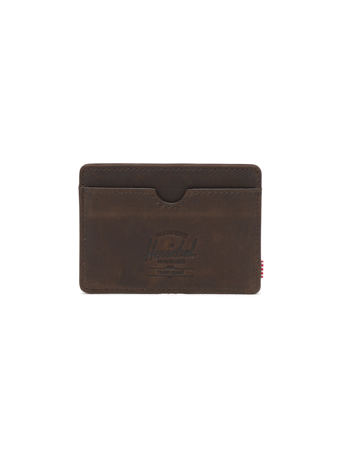 The Herschel Charlie Leather Card Holder Wallet in brown features a central pocket, curved card slot, RFID blocking, clean stitching, embossed logo on the front, and a small red striped tag on the right side.