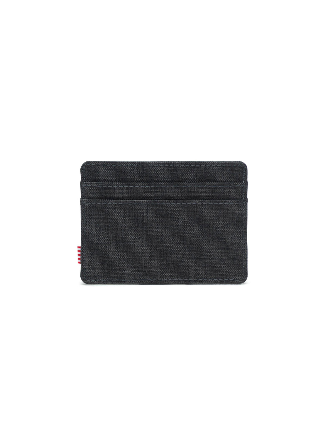 The Herschel Charlie Compact Card Holder Wallet is a minimalist black card holder with two horizontal card slots and a small red-and-white tag on the left edge, shown on a white background.
