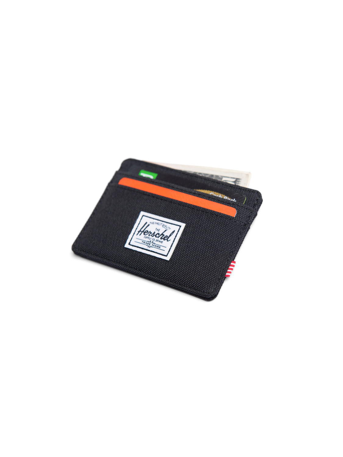 A Herschel Charlie Compact Card Holder Wallet in black, featuring multiple card slots with cards and a folded bill visible in its pockets, displayed on a white background.