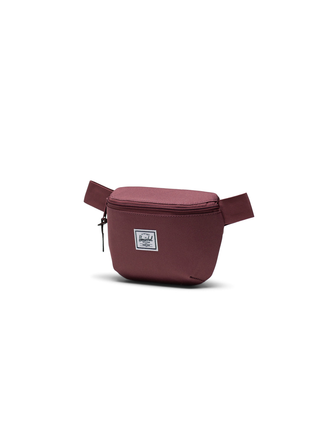 The Herschel Fourteen Hip Pack in maroon features a zippered main compartment, adjustable strap, and signature white logo patch on the front—ideal for carrying essentials. Shown against a plain white background.