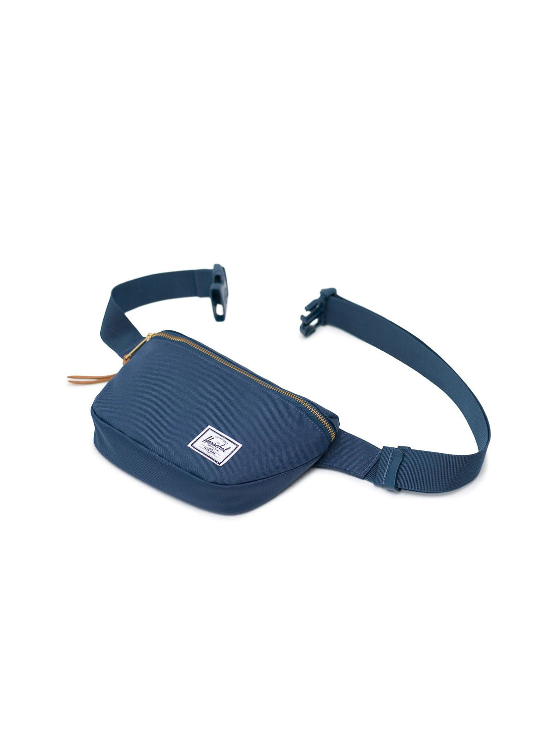 The Herschel Fifteen Hip Pack in navy features an adjustable strap, metal zipper on the main compartment, plastic buckle, and a small white rectangular logo label on the front, shown against a white background.