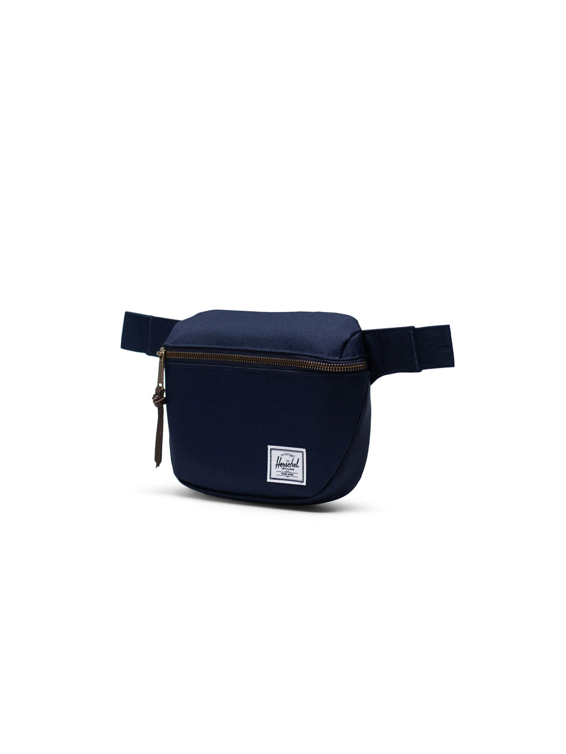 The Herschel Fifteen Hip Pack is a navy blue fabric bag with a metal zipper on the main compartment, an adjustable strap for comfort, and a small white rectangular logo patch on the front.