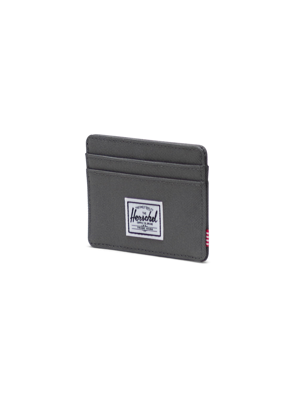The Herschel Charlie Compact Card Holder Wallet in grey offers multiple card slots and features a white rectangular Herschel logo patch on the front, shown against a plain white background.