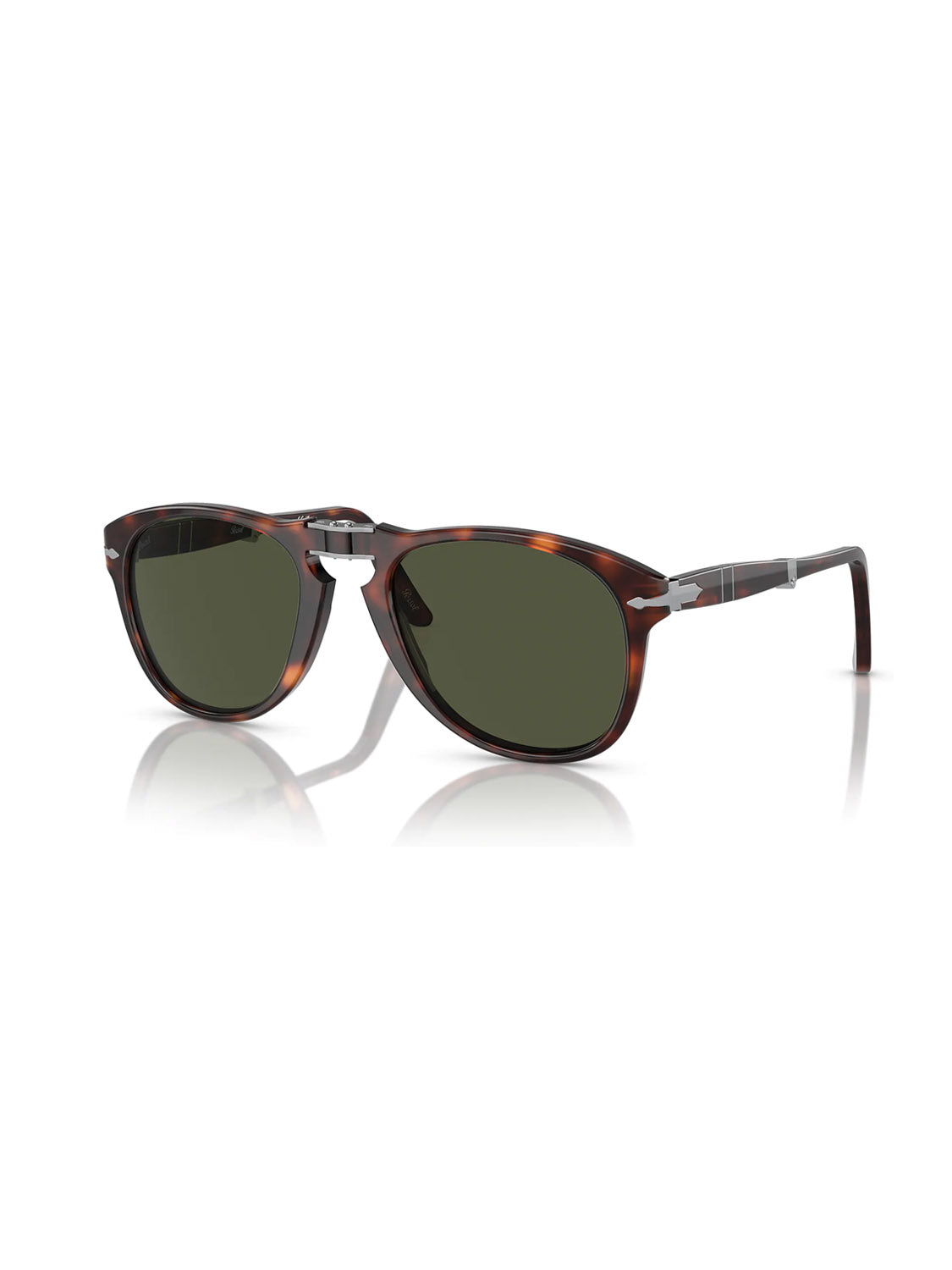 The Persol PO714 sunglasses feature a brown tortoiseshell acetate frame with green crystal lenses, silver temple accents, and a silver bridge. The frame is slightly angled, highlighting its design and reflection on a white surface.