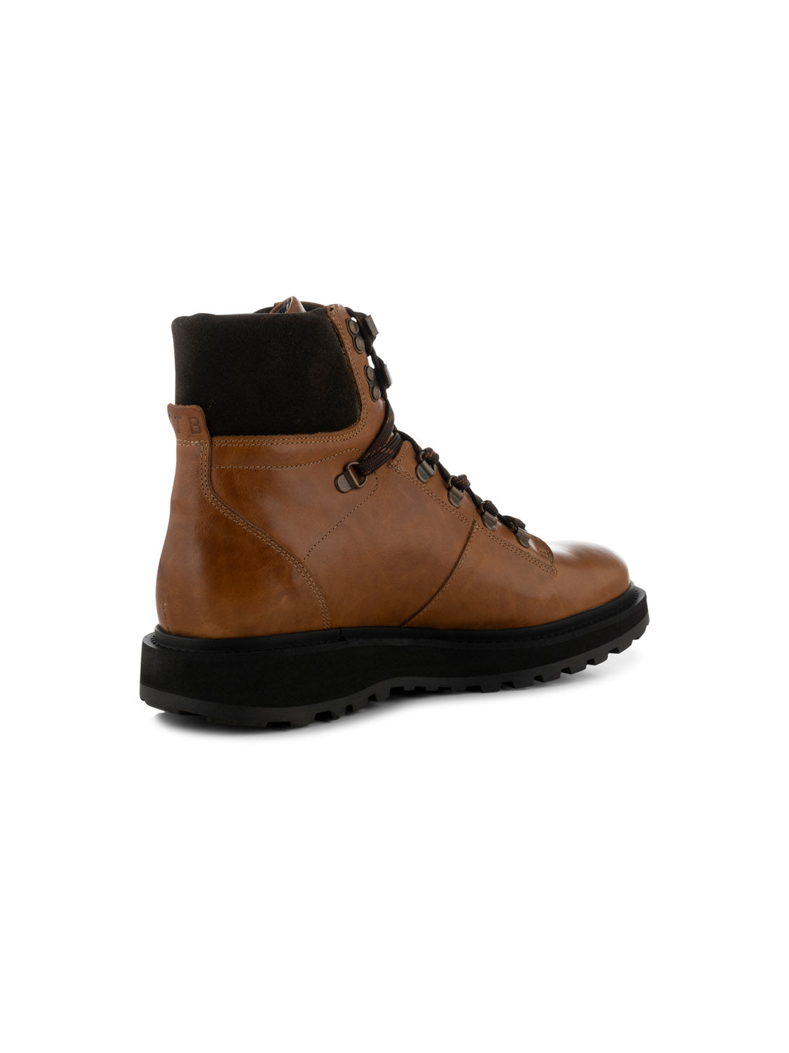 The Kite Hiker Warm by Shoe The Bear is a brown leather hiking boot with black laces, a thick black sole, and padded ankle support. Crafted from LWG-waxed leather, its designed for winter and shown at an angled view to highlight the side and back.