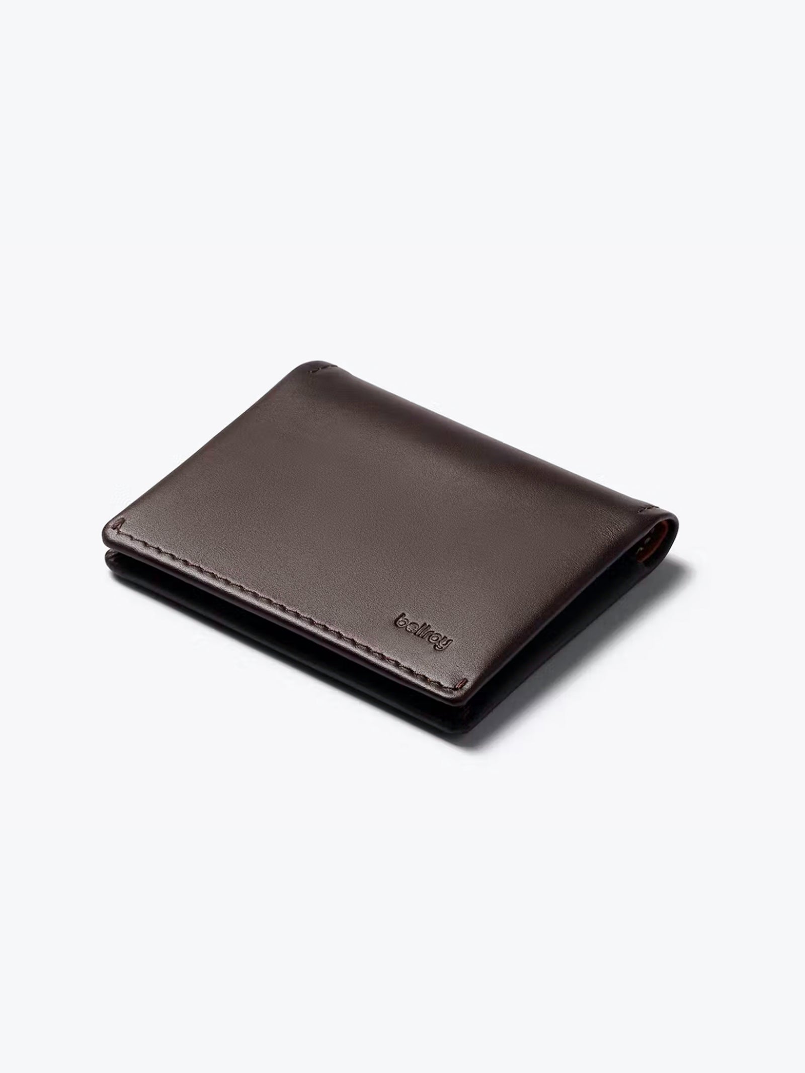 The Bellroy Slim Sleeve Wallet, in dark brown with minimalist design, subtle stitching, and a small embossed logo, sits on a plain light background. This slim, pocket-friendly wallet is perfect for everyday use.