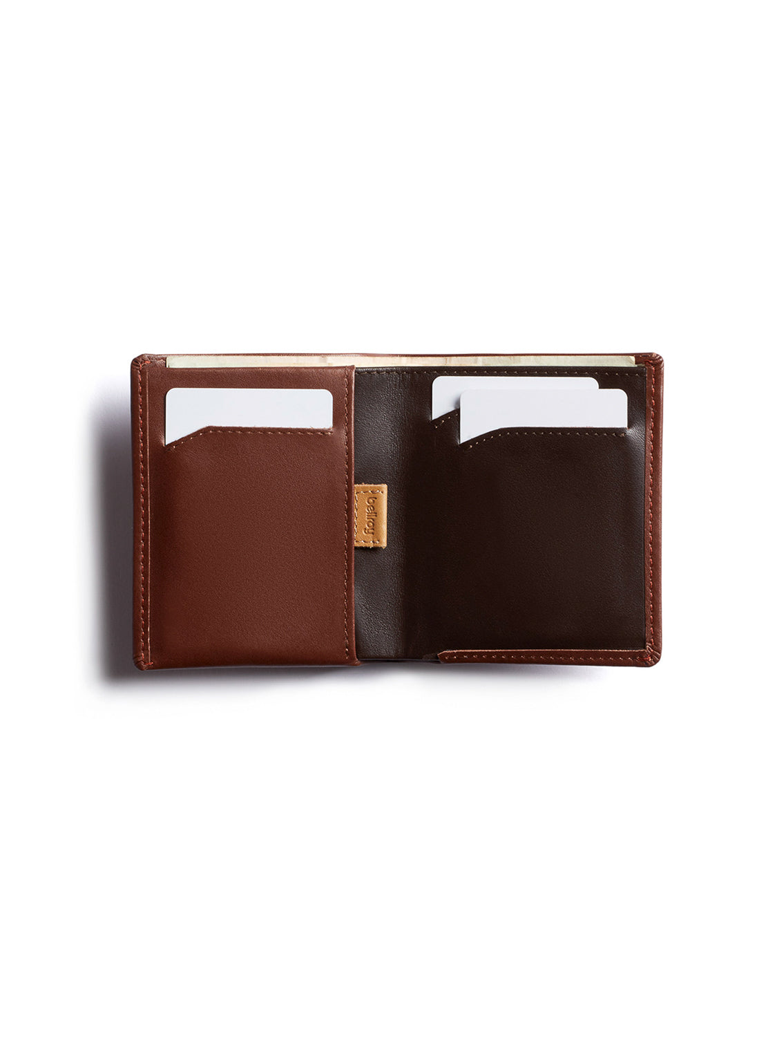 The Bellroy Note Sleeve Wallet is shown open on a white background, featuring two visible card slots holding white cards. The left side is light brown, while the right side is a darker brown.
