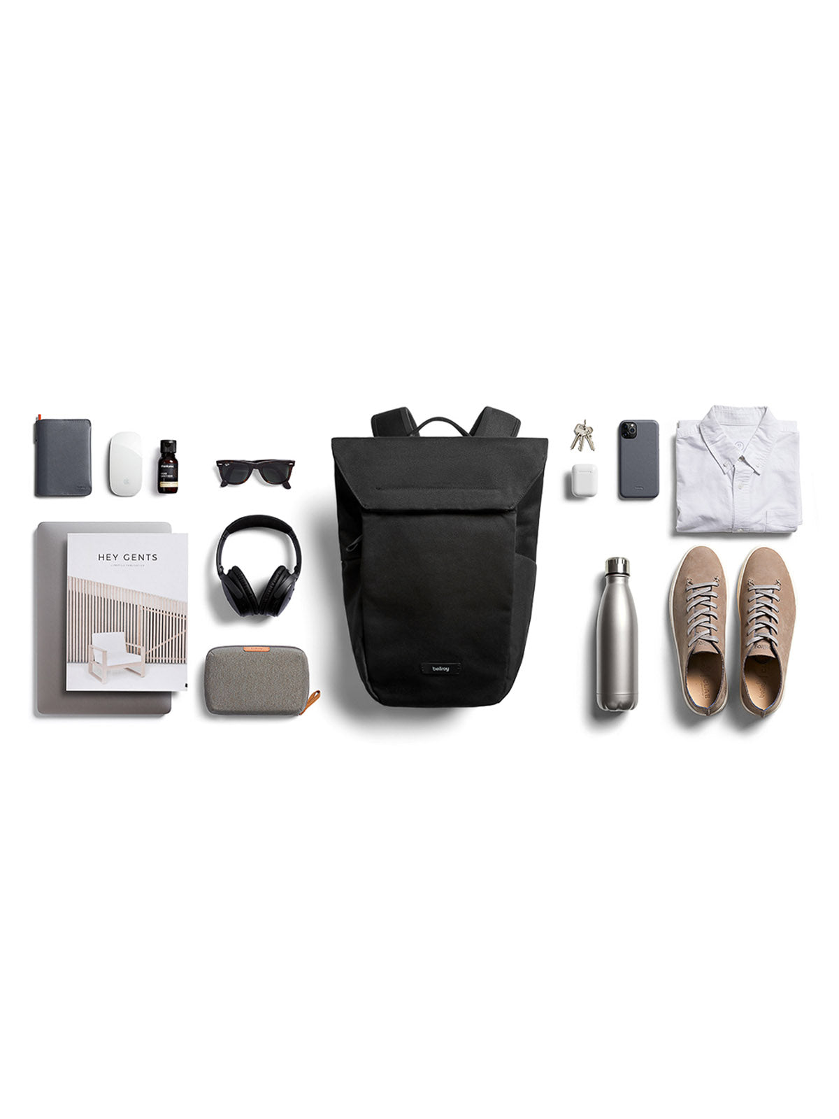 The Bellroy Melbourne Backpack - 18L in black sits on a white background, surrounded by a white shirt, beige shoes, sunglasses, smartphone, notebook, wireless earbuds, headphones, water bottle, small case, book, keys and charger.