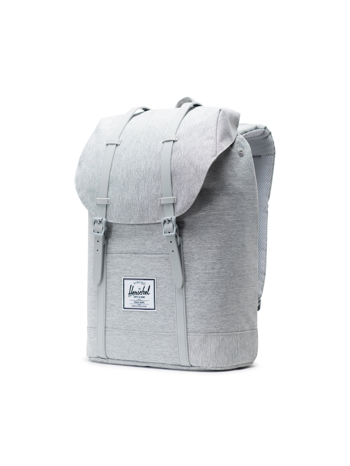 A light gray Herschel Retreat Backpack with a flap top, dual front buckle straps, a white rectangular logo patch, padded shoulder straps, and a laptop sleeve, shown against a white background.