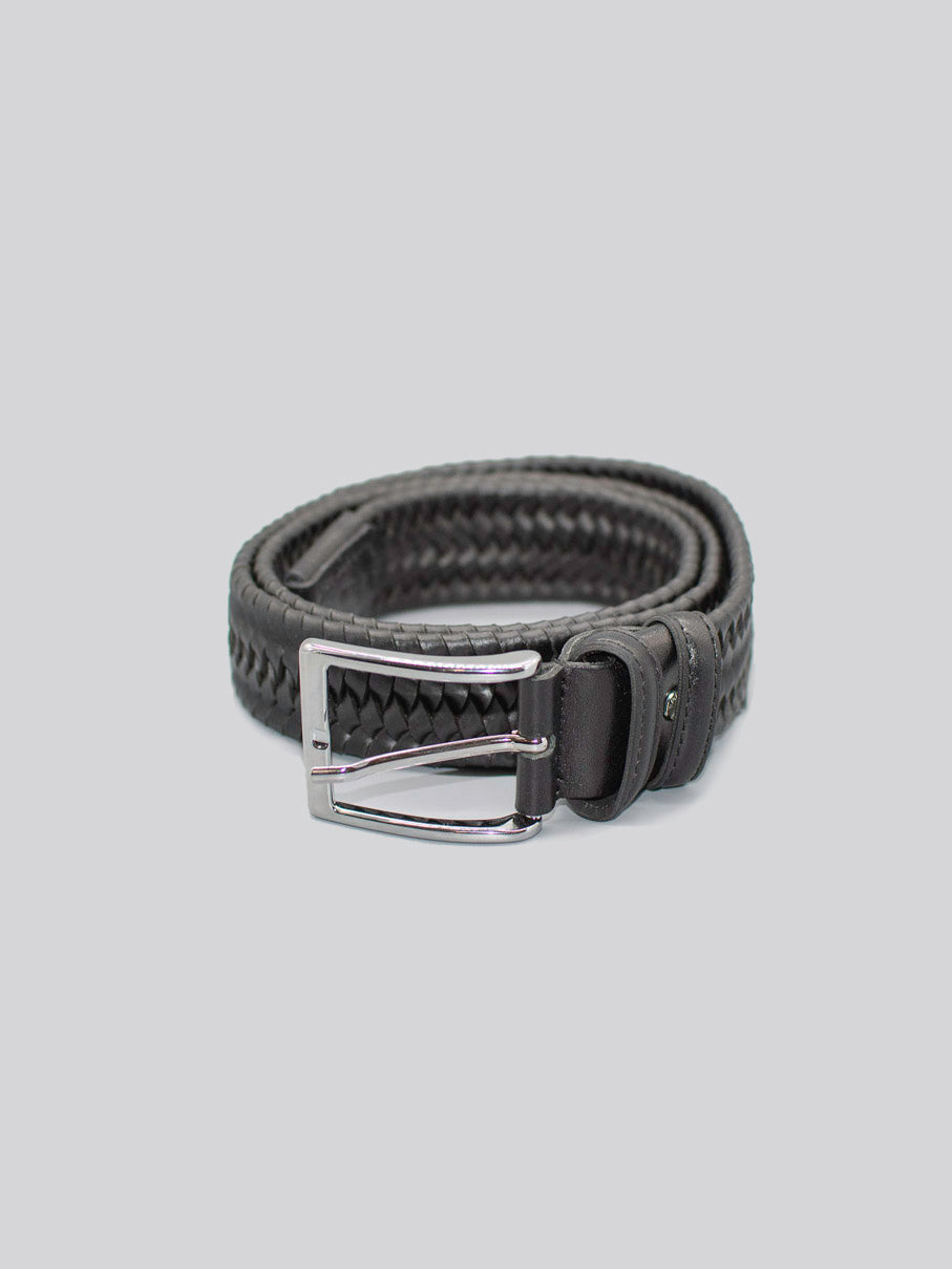 The 4558 Made in Italy Braided Leather Belt by ID Menswear, featuring black genuine leather and a silver buckle, is rolled up neatly on a plain light gray background.